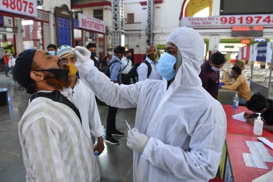 A health worker wearing protective gear takes a nasal swab.  (AFP)