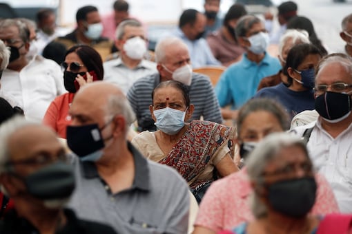 People wait to receive a dose of Covishield at a government facility (Reuters)