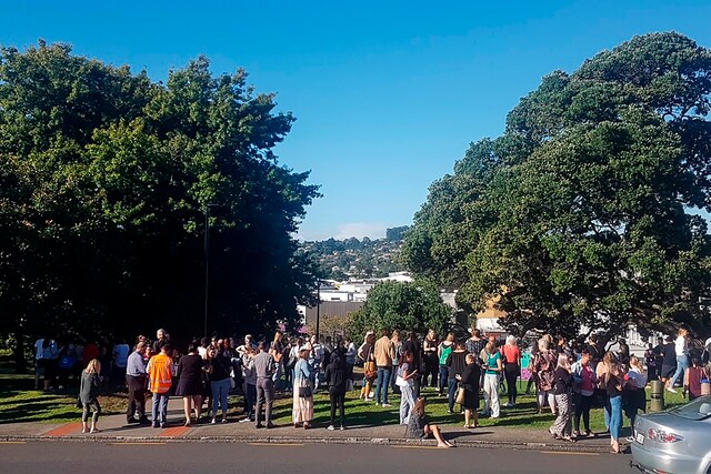 People gather on high ground in Whangarei, New Zealand, as a tsunami warning is issued on Friday. (AP)