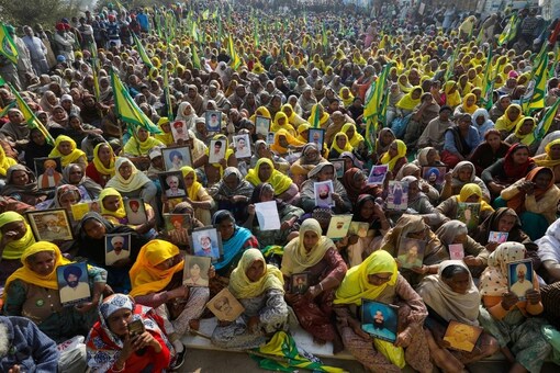 Women, including widows of farmers believed to have killed themselves over debt attend a protest against farm bills at Tikri border. 