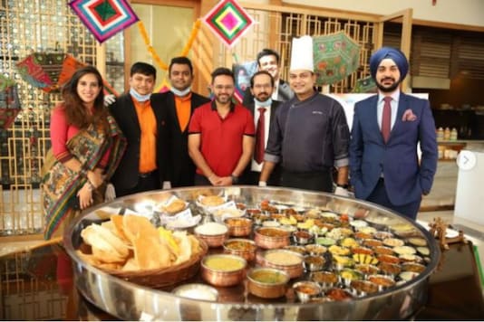Cricketer Parthiv Patel, along with restaurant staff, posing with the mammoth Motera Thali.