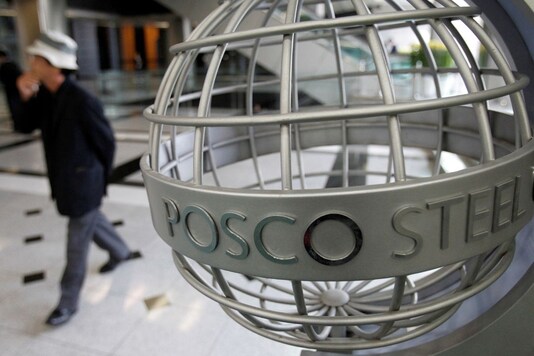 A man walks past a logo of steelmaker POSCO. Reuters/File Photo
