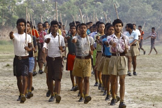 Volunteers of the RSS hold sticks as they march during a training session at Tatiberia village in West Bengal in 2015. Representative image. Reuters
