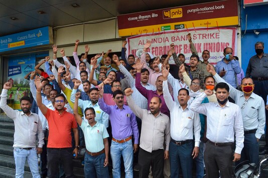 Bank employees raised slogans during a protest in support of the two-day nationwide strike, called by United Forum of Bank Unions (UFBU), against the proposed privatisation of two state-owned lenders, in Varanasi, on March 16. (PTI Photo) 
