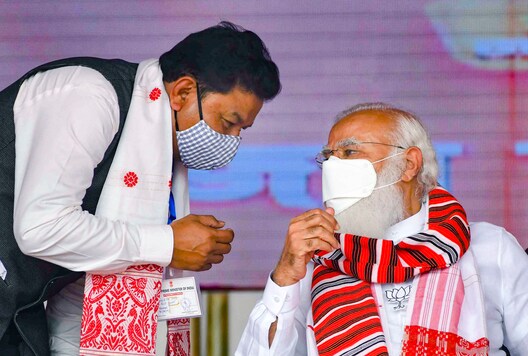 Golaghat: Prime Minister Narendra Modi talks with Assam BJP President Ranjit Kumar Dass during an election campaign rally for Assam Assembly polls, at Kamargaon in Golaghat, Sunday, March 21, 2021. (PTI Photo) (PTI03_21_2021_000049B)