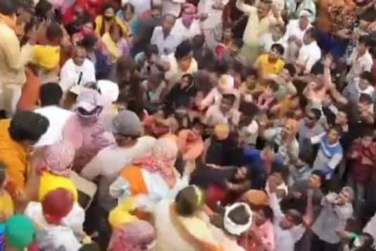 Screenshot showing people huddled together at Mathura temple.  