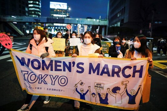 Demonstrators hold a banner as they take part in a march to call for gender equality in Tokyo.

REUTERS/Issei Kato - RC2Y6M9V1QX4