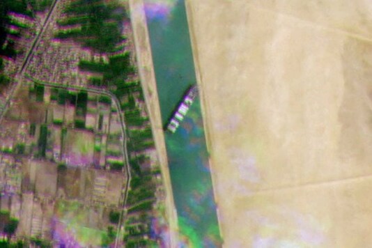 The incident began on Tuesday when strong winds blasted in the region and kicked up sands along the banks. The narrow waterway and the difficulty in navigating due to poor visibility resulted in the crew losing control of the ship which careened sideways into a sandy embankment. Tugs and diggers have so far failed to dislodge a massive container ship stuck in the Suez Canal on Wednesday. Photo: AFP