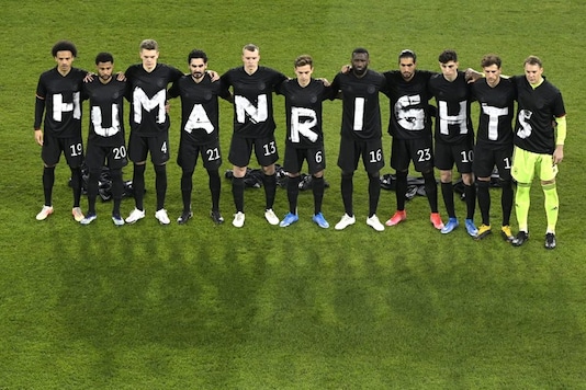 The German team lined up in black shirts, each with one white letter to spell out “HUMAN RIGHTS" (Photo Credit: AP)