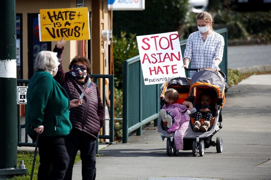 People wave signs at an intersection during a pre-planned rally against anti-Asian hate crimes in Newcastle, Washington. (Image for representational purpose)

REUTERS/Lindsey Wasson - RC29DM9HMOQ4