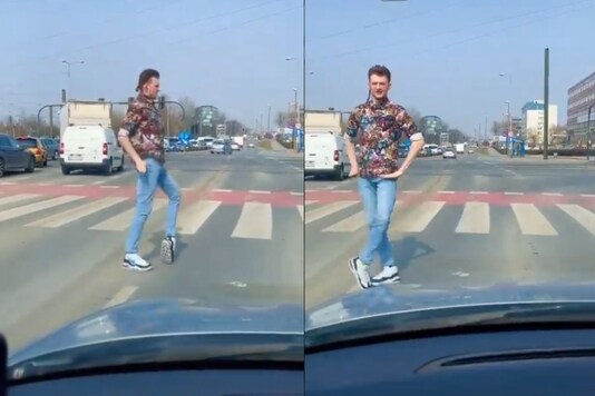 The video shows the man as he gets off the vehicle at a traffic signal and starts moonwalking on the zebra crossing.  (Credit: David Herrmann/Twitter)
