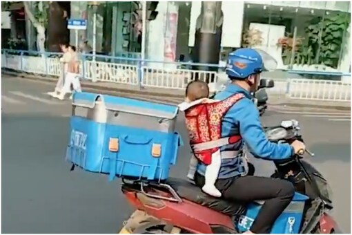Delivery man with baby | Image credit: Twitter