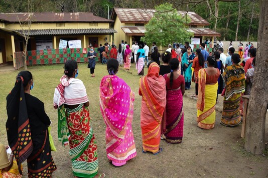 Voters queue up to cast their votes during the second phase of the Assam Assembly election, at a polling station in Dhekiabari, Morigaon district. (File pic: PTI)