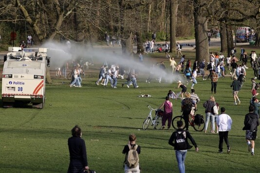 Police use a water cannon during protests at a park in Brussels. (Credit: AP)
