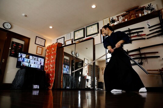 The founder of Bugaku and Samurai martial arts instructor Koshiro Minamoto demonstrates martial arts during an online class.

 REUTERS/Kim Kyung-Hoon