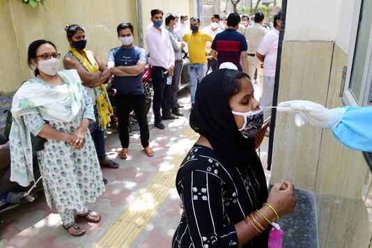 A health worker collects a nasal sample for COVID-19 test in New Delhi. (PTI)