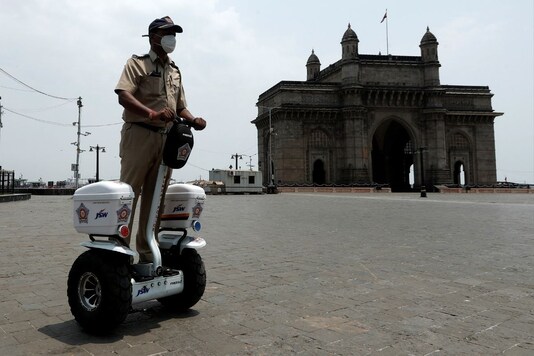 A police officer patrols on a Segway along the promenade outside the Gateway of India during curfew in Mumbai. REUTERS
