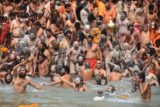 Seers seen huddled together in Haridwar on River Ganga banks to take the holy dip, throwing Covid-19 caution to air.  (Picture shared by Kumbh admin)