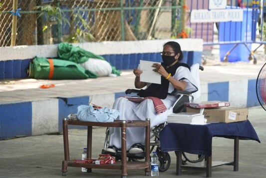 West Bengal chief minister Mamata Banerjee paints while  sitting in a wheelchair during a protest. 