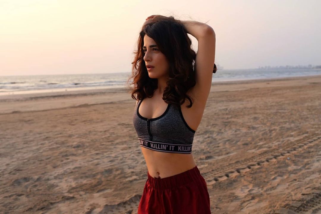 Radhika Madan shows off her hot body as she exercises on a beach. 