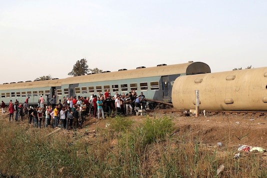 People gather at the site where train carriages derailed in Qalioubia province, Egypt. (Reuters)