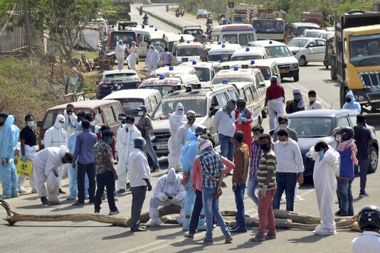 Ambulances carrying the bodies of COVID-19 victims, parked near the Ghagra Mukti Dham during a protest by drivers against alleged mismanagement in the burials of COVID-19 victims, in Ranchi on Monday. (PTI)