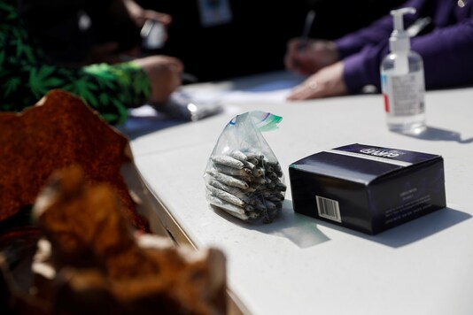 Members of the Global Marijuana March distribute joints in exchange for proof of vaccination against COVID-19 in Union Square, New York City, US. (Reuters)