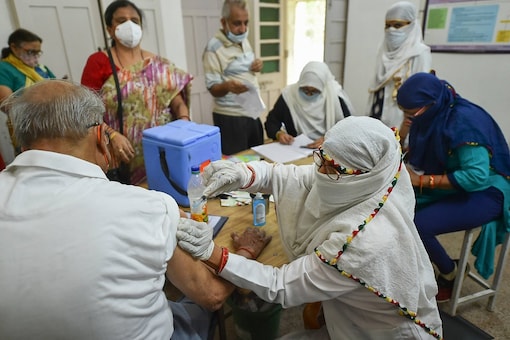 A beneficiary receives Covid-19 vaccine shot at a Covid-19 centre.