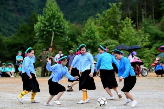 Ethnic San Chi women dressed in traditional costumes play a friendly football match as part of the Soong Co festival celebrations in northern Vietnam's Quang Ninh province. (Photo Credit: AFP)