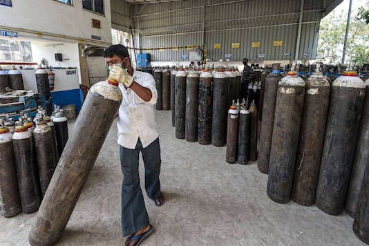 Workers refill cylinders with medical oxygen for supply for COVID-19 patients. (PTI)