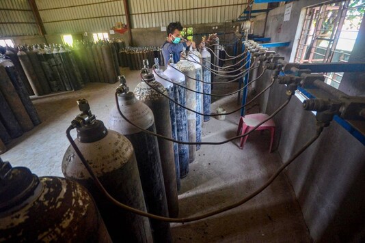 A technician refills medical oxygen cylinders in an industrial facility to supply to hospitals for the treatment of COVID-19 patients. (PTI photo)