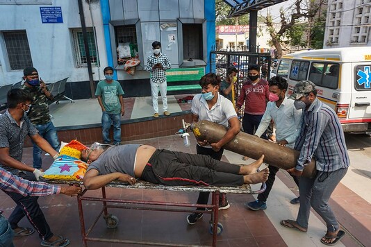 A COVID-19 patient on oxygen support waits to be admitted in a hospita in Kanpur, Wednesday,. (PTI)