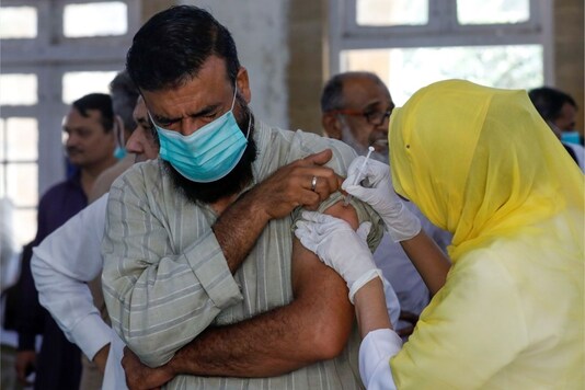 A man receives a dose of the coronavirus disease (Covid-19) vaccine, at a vaccination center in Karachi, Pakistan. REUTERS