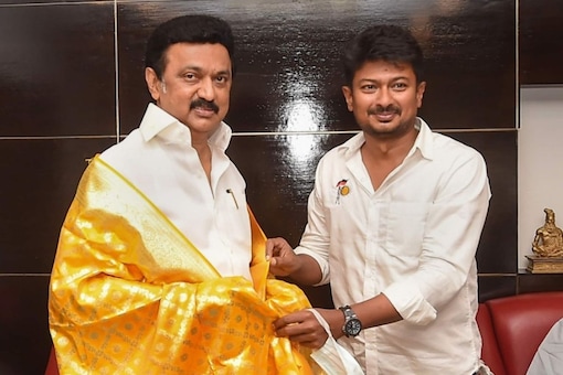 DMK youth wing secretary Udhayanidhi Stalin shares his victory with his father and party president MK Stalin after winning the Tamil Nadu Assembly polls at his residence ,in Chennai, Sunday. (PTI)