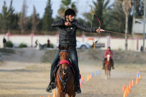A Palestinian rider shoots an arrow at a target during a horseback archery training session in Zawayda in the central Gaza Strip.

REUTERS/Ibraheem Abu Mustafa