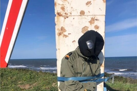 A photo obtained by Reuters on May 8, 2021, said to be shot March 2019 at Solenzara Air Base, Corsica, France, shows a man tied to a target on a firing range who French lawyer Frederic Berna identifies as his client, a French Air Force pilot who filed a complaint for hazing. via Frederic Berna/via REUTERS.