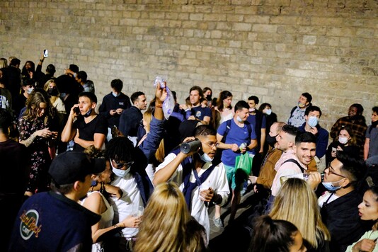 People celebrate on a street in the neighborhood of Born, as the state of emergency decreed by the Spanish government gets lifted in Barcelona, Spain. (Reuters)