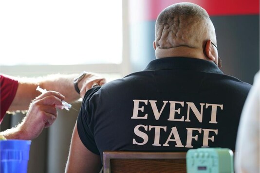 A Wells Fargo Center worker receives a Johnson & Johnson COVID-19 vaccination before an NHL hockey game between the Philadelphia Flyers and the New Jersey Devils, Monday, May 10, 2021, in Philadelphia. (AP Photo/Matt Slocum)