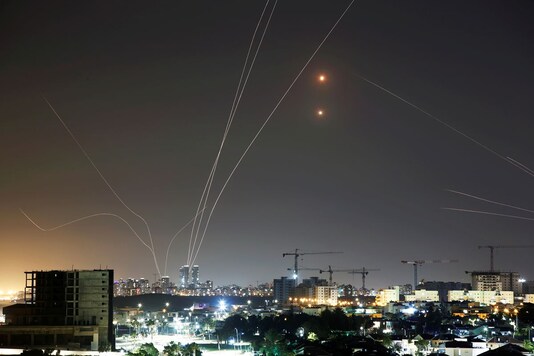 Streaks of light are seen as Israel's Iron Dome anti-missile system intercepts rockets launched from the Gaza Strip towards Israel. (Reuters)