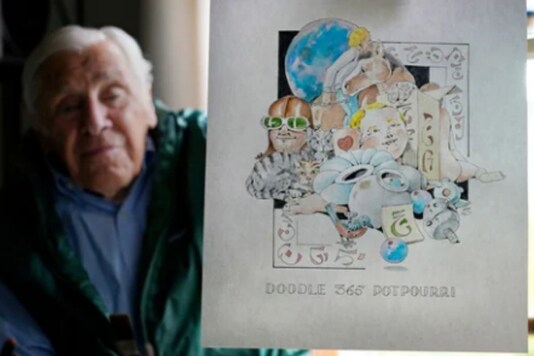 Artist Robert Seaman holds up the 365th daily doodle sketch in his room at an assisted living facility. (AP)