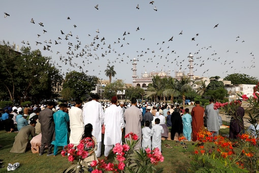 Pakistani Muslims gather to celebrate Eid al-Fitr prayers to mark the end of the holy fasting month of Ramadan, as the outbreak of the coronavirus disease (COVID-19) continues in Karachi, Pakistan May 13, 2021. (Reuters)