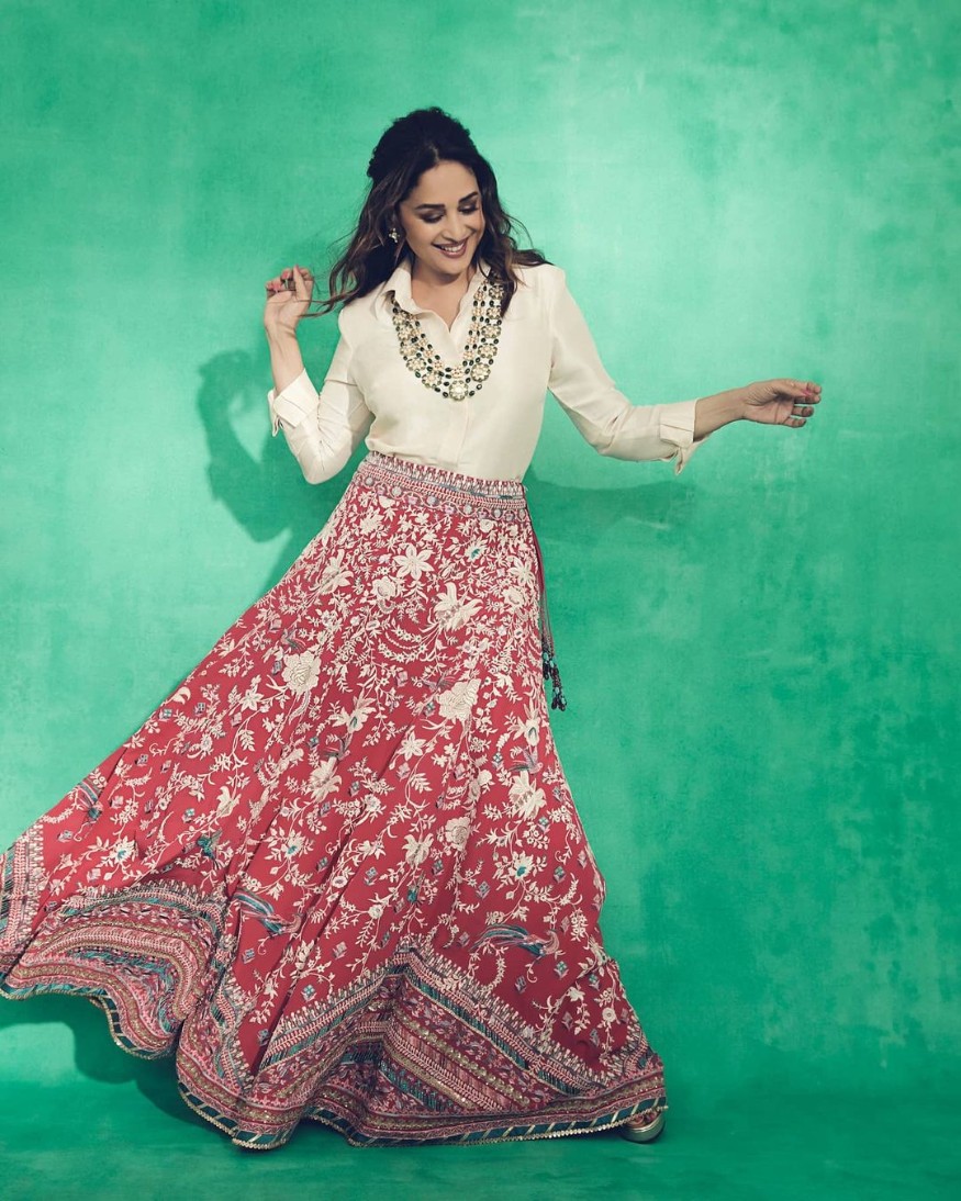  The actress exudes charm in the fusion outfit. She aces the bejewelled red skirt and white silk shirt adorning it with a long necklace. (Image: Instagram)