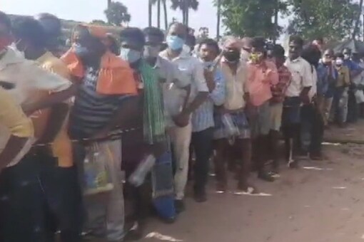 People in very large numbers gather at Krishnapatnam village in Nellore district where an Ayurvedic practitioner is distributing medicines for COVID19; social distancing norms flouted.