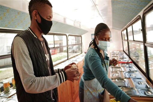 Sanele Msibi assists a customer inside the Skhaftin bus in Johannesburg, South Africa. 

REUTERS/Kim Harrisberg