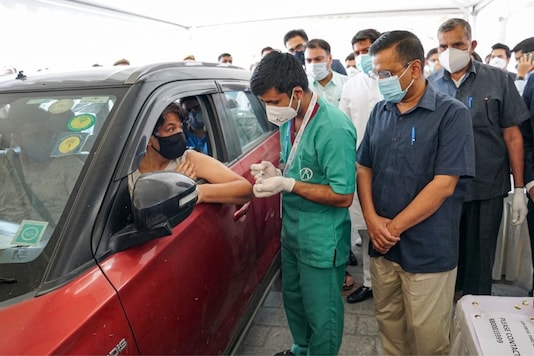 New Delhi: Chief Minister Arvind Kejriwal visits the drive-through vaccination centre started from today, in Dwarka. (PTI Photo)(