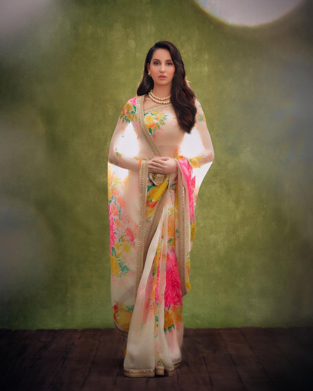  Nora Fatehi paints a picture of elegance in the floral-printed saree. (Image: Instagram)