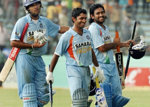 Indian batsmen Dinesh Karthik (C), Mahendra Singh Dhoni (R) and runner Yuvraj Singh (L) walk off the grounds after India won the first One Day International (ODI) match between India and Bangladesh in Dhaka, 10 May 2007. India defeated Bangladesh by five wickets to take a 1-0 lead in the three-match one-day series. AFP PHOTO/Deshakalyan CHOWDHURY (Photo by DESHAKALYAN CHOWDHURY / AFP)