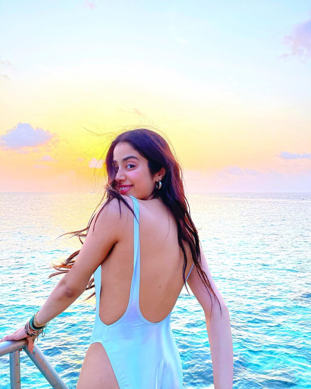  Janhvi Kapoor's shiny swimsuit is apt for the summers. (Image: Instagram)