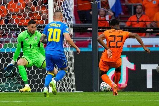 Denzel Dumfries of the Netherlands, right, makes an attempt to score (Image: AP)