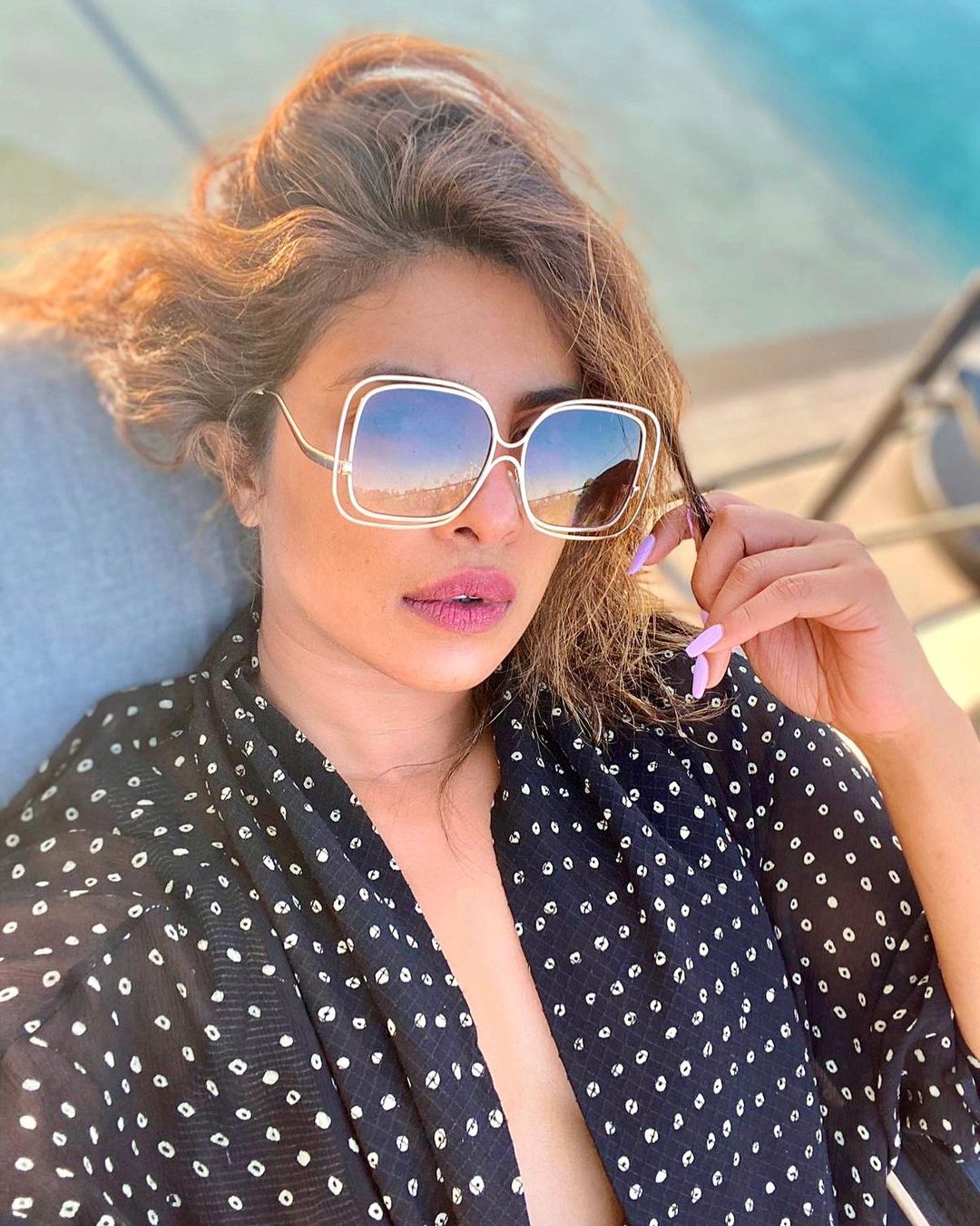  Priyanka Chopra glams it up in a plunging black dress and stylish sunglasses. (Image: Instagram)